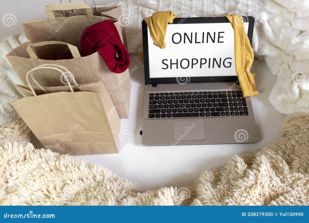 Picture of: Laptop on the Bed with Online Shopping Written on the Screen with
